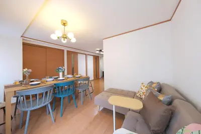 a living room with a couch and a table and chairs at ever Inn Higashi koenji in Tokyo
