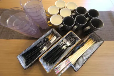 a table with utensils and spoons and forks at ever Inn Higashi koenji in Tokyo