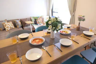 a wooden table with bowls of food on it at ever Inn Higashi koenji in Tokyo
