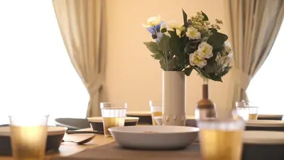 a table with a vase of flowers on top of it at ever Inn Higashi koenji in Tokyo