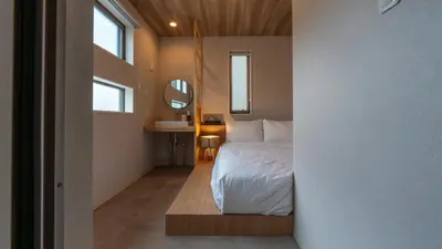 a bedroom with a bed and a mirror at \u672c\u753a3a\u30db\u30c6\u30eb in Tokyo