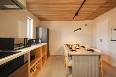 a large kitchen with a long table in it at \u672c\u753a3a\u30db\u30c6\u30eb in Tokyo