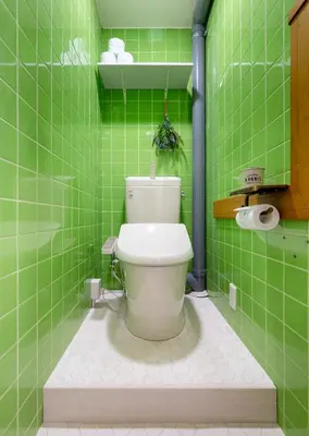 a green tiled bathroom with a toilet in it at HanaStay-Tokyo Ueno 2 Stops in Tokyo