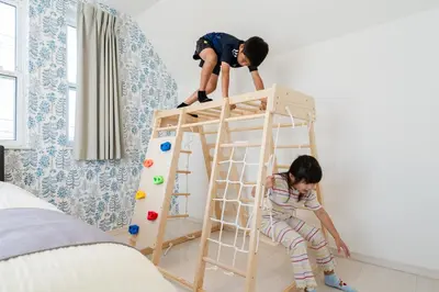 two children playing on a ladder in a bedroom at Vacation Stay Koiwa in Tokyo