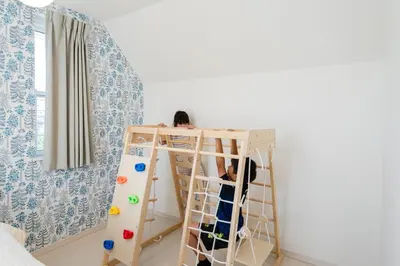 a child playing in a bunk bed in a room at Vacation Stay Koiwa in Tokyo