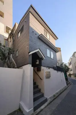 a building with a stairway leading up to a building at Kukunochi in Tokyo