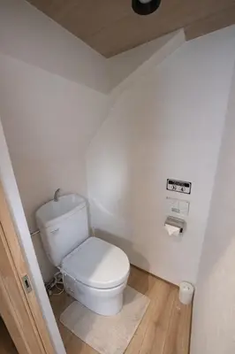 a bathroom with a white toilet in a room at Kukunochi in Tokyo