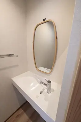 a bathroom with a white sink and a mirror at Kukunochi in Tokyo