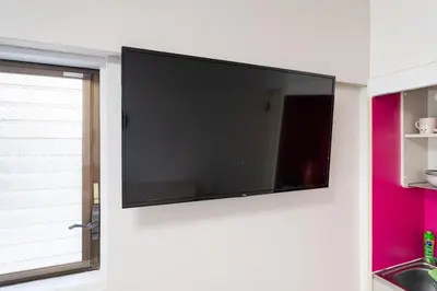 a flat screen tv hanging on a wall at Shinjuku,Higashi Shinjuku Sta, 5min walk,WiFi in Tokyo