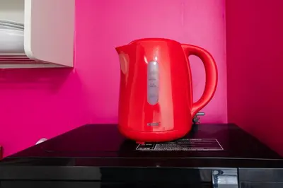 a red kettle sitting on top of a counter at Shinjuku,Higashi Shinjuku Sta, 5min walk,WiFi in Tokyo