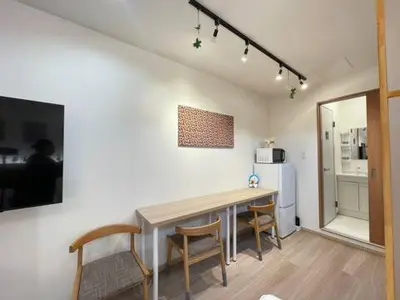 a kitchen with a table and chairs in a room at \u4e0b\u753a\u65b0\u5c0f\u5ca9\u7f8e\u5e78\u30cf\u30a6\u30b9101 in Tokyo