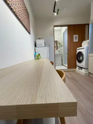 a kitchen with a wooden table in a room at \u4e0b\u753a\u65b0\u5c0f\u5ca9\u7f8e\u5e78\u30cf\u30a6\u30b9101 in Tokyo