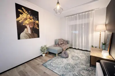 a living room with a chair and a painting on the wall at KiMura in Tokyo