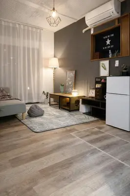 a living room with a white refrigerator and a table at KiMura in Tokyo