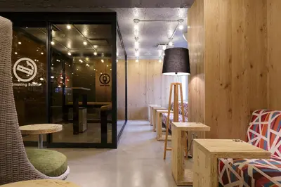 a restaurant with tables and chairs and a lamp at Booth Netcafe & Capsule in Tokyo
