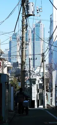 a person sitting on a bench on a city street at SunRiseStay Shibuya\u6da9\u8c37 in Tokyo