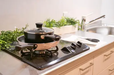 a pots and pans sitting on a stove in a kitchen at Premium Apartment Hotel Tokyo Shinjuku in Tokyo