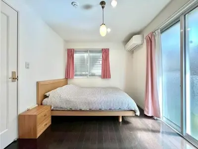 a bedroom with a bed and a window with red curtains at Spacious 3-Bedroom Villar and parking - Central Tokyo nearby to Shinjuku, Shibuya, Ginza in Tokyo