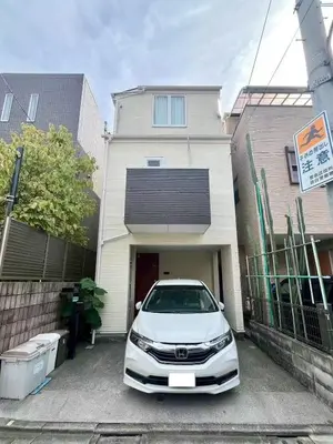 a white car parked in front of a house at Spacious 3-Bedroom Villar and parking - Central Tokyo nearby to Shinjuku, Shibuya, Ginza in Tokyo