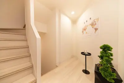 a staircase in a house with a potted plant at HOTEL Edogawa in Tokyo