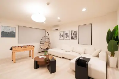 a living room with a white couch and a table at HOTEL Edogawa in Tokyo