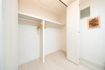 a room with white walls and a white closet at HOTEL Edogawa in Tokyo