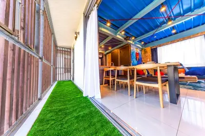 a balcony with green flooring and a table and chairs at 3 min walk from Sangenjaya Sta, 90square meters, Bouldering in Tokyo
