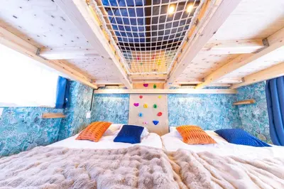 a bedroom with a large bed with two pillows at 3 min walk from Sangenjaya Sta, 90square meters, Bouldering in Tokyo