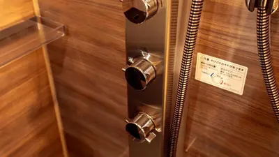 a bathroom with a metal door with a sign on it at \u672c\u753a3b\u30db\u30c6\u30eb in Tokyo