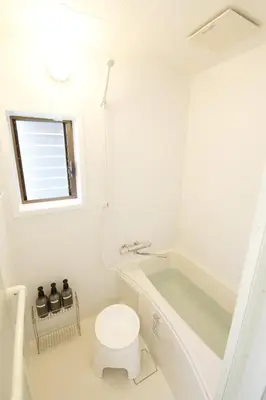 a white bathroom with a tub and a toilet at \u56db\u3064\u6728\u6238\u5efa2165 in Tokyo