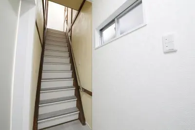 a staircase in a building with a window at \u56db\u3064\u6728\u6238\u5efa2165 in Tokyo