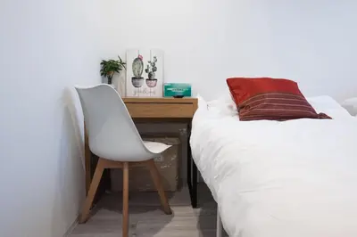 a desk with a chair next to a bed at Boa Sorte Hotel AD0515 in Tokyo