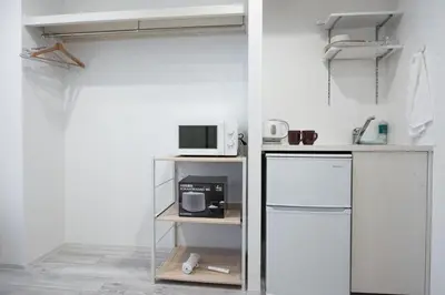 a kitchen with a white refrigerator and a microwave at Boa Sorte Hotel AD0515 in Tokyo