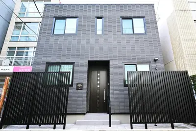 a house with a black door and a black fence at NY Hotel Premium 1 \u65b0\u5bbf2\u968e\u5efa\u30663\u5ba41\u30d0\u30b9\u30eb\u30fc\u30e01\u30b7\u30e3\u30ef\u30fc2\u30c8\u30a4\u30ec in Tokyo