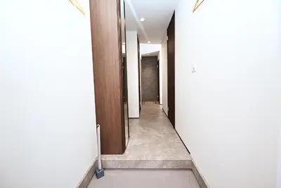 a hallway with white walls and wooden doors at NY Hotel Premium 1 \u65b0\u5bbf2\u968e\u5efa\u30663\u5ba41\u30d0\u30b9\u30eb\u30fc\u30e01\u30b7\u30e3\u30ef\u30fc2\u30c8\u30a4\u30ec in Tokyo