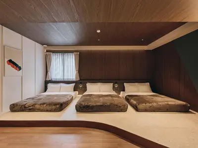 two beds are sitting in a room with at illi Eme Tokyo-Toranomon in Tokyo