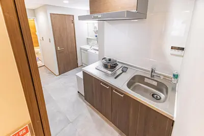 a small kitchen with a sink and a counter at Sunny hotel 2 min walk to Iriya Station Direct to Ueno and Asakusa in Tokyo