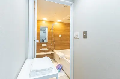a bathroom with a tub and a sink and a toilet at Sunny hotel 2 min walk to Iriya Station Direct to Ueno and Asakusa in Tokyo