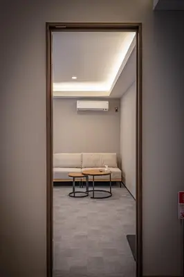a hallway with a couch and a table in a room at Sunny hotel 2 min walk to Iriya Station Direct to Ueno and Asakusa in Tokyo