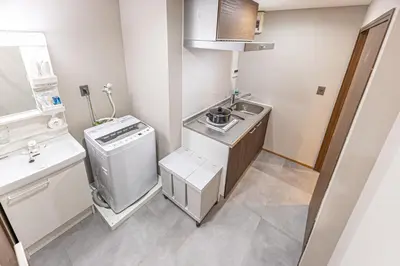 a small kitchen with a sink and a dishwasher at Sunny hotel 2 min walk to Iriya Station Direct to Ueno and Asakusa in Tokyo