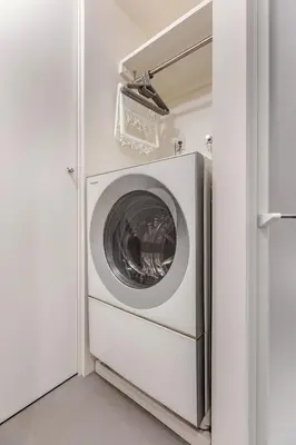 a washer and dryer in a white laundry room at mtk\u6238\u8d8a3\u4e01\u76ee01 in Tokyo