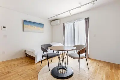 a room with a table and chairs and a bed at mtk\u6238\u8d8a3\u4e01\u76ee01 in Tokyo