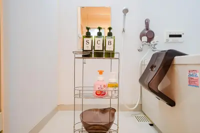 a shelf with bottles on it in a room at Yuka's House Otsuka Perfect for children in Tokyo