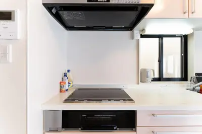 a kitchen with a stove top oven in a kitchen at Yuka's House Otsuka Perfect for children in Tokyo