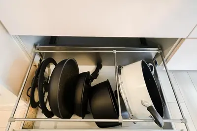 a rack of pots and pans in a refrigerator at Yuka's House Otsuka Perfect for children in Tokyo
