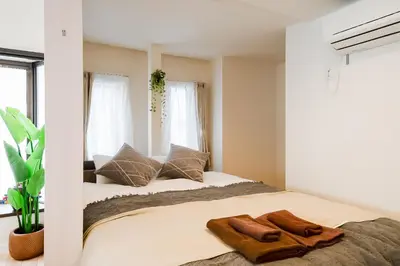 a bedroom with a large bed with two pillows at Yuka's House Otsuka Perfect for children in Tokyo
