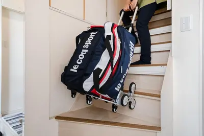 a person is walking down the stairs with a bag at Yuka's House Otsuka Perfect for children in Tokyo