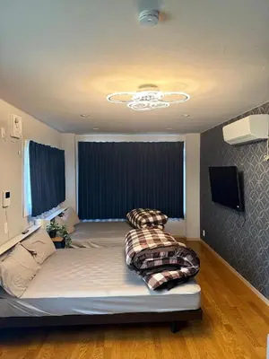 a bedroom with a large bed in a room at The Asakusa Townhouse in Tokyo