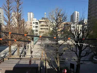 a traffic light in a city with tall buildings at The Asakusa Townhouse in Tokyo