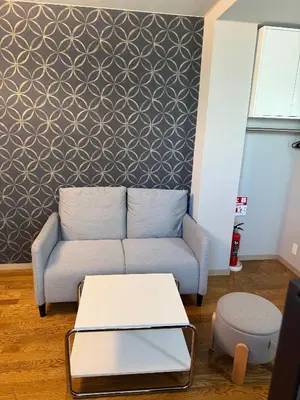 a living room with a couch and a table at The Asakusa Townhouse in Tokyo